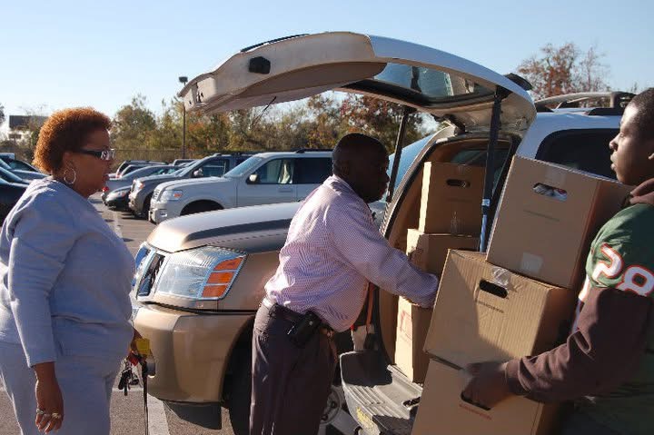 Willie Jones loading donation boxes into a neighbor's vehicle