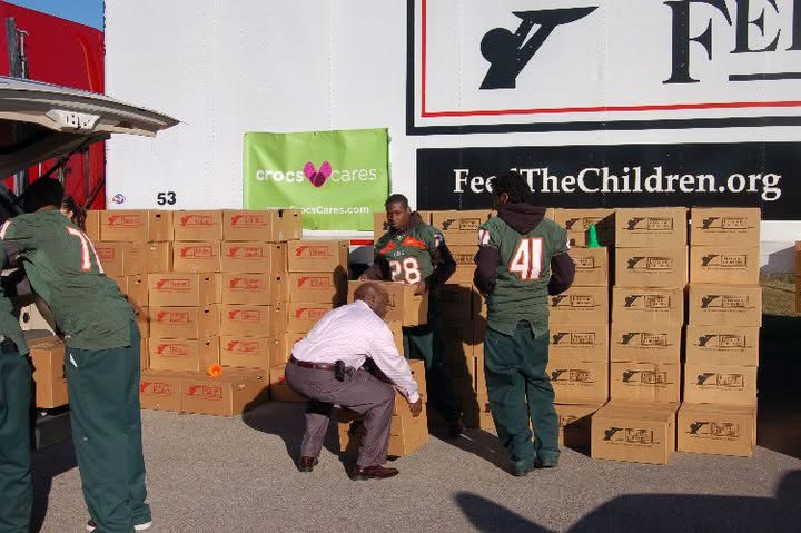 Willie Jones organizing supplies with volunteers at a Feed the Children truck